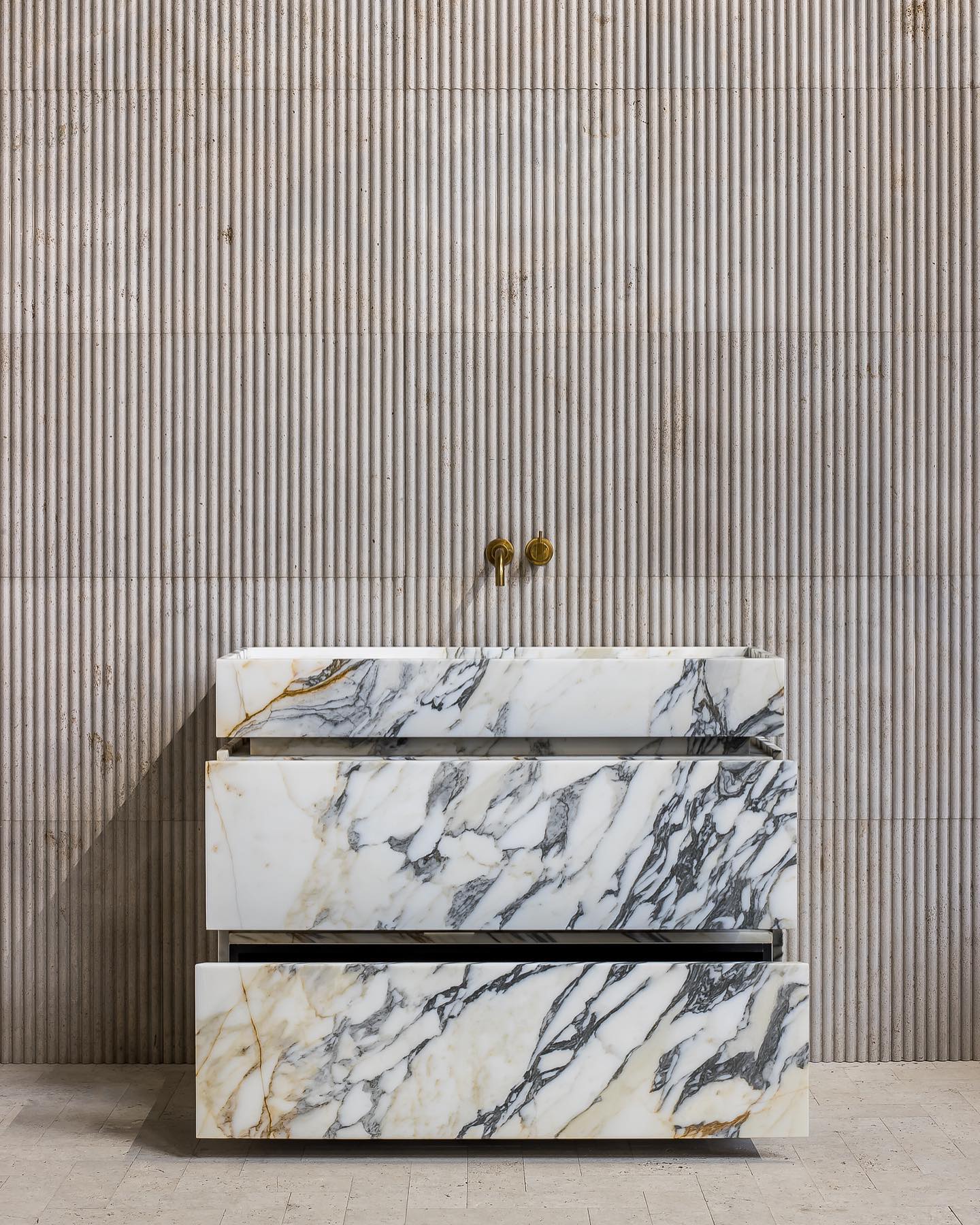 Venice marble vanity in Calacatta Gold with drawers open showing storage and integrated stone design