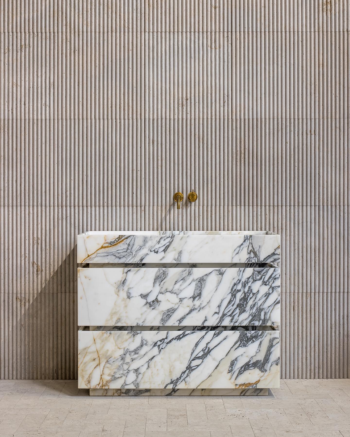 Venice marble vanity in Calacatta Gold marble with natural veining in a luxury bathroom setting