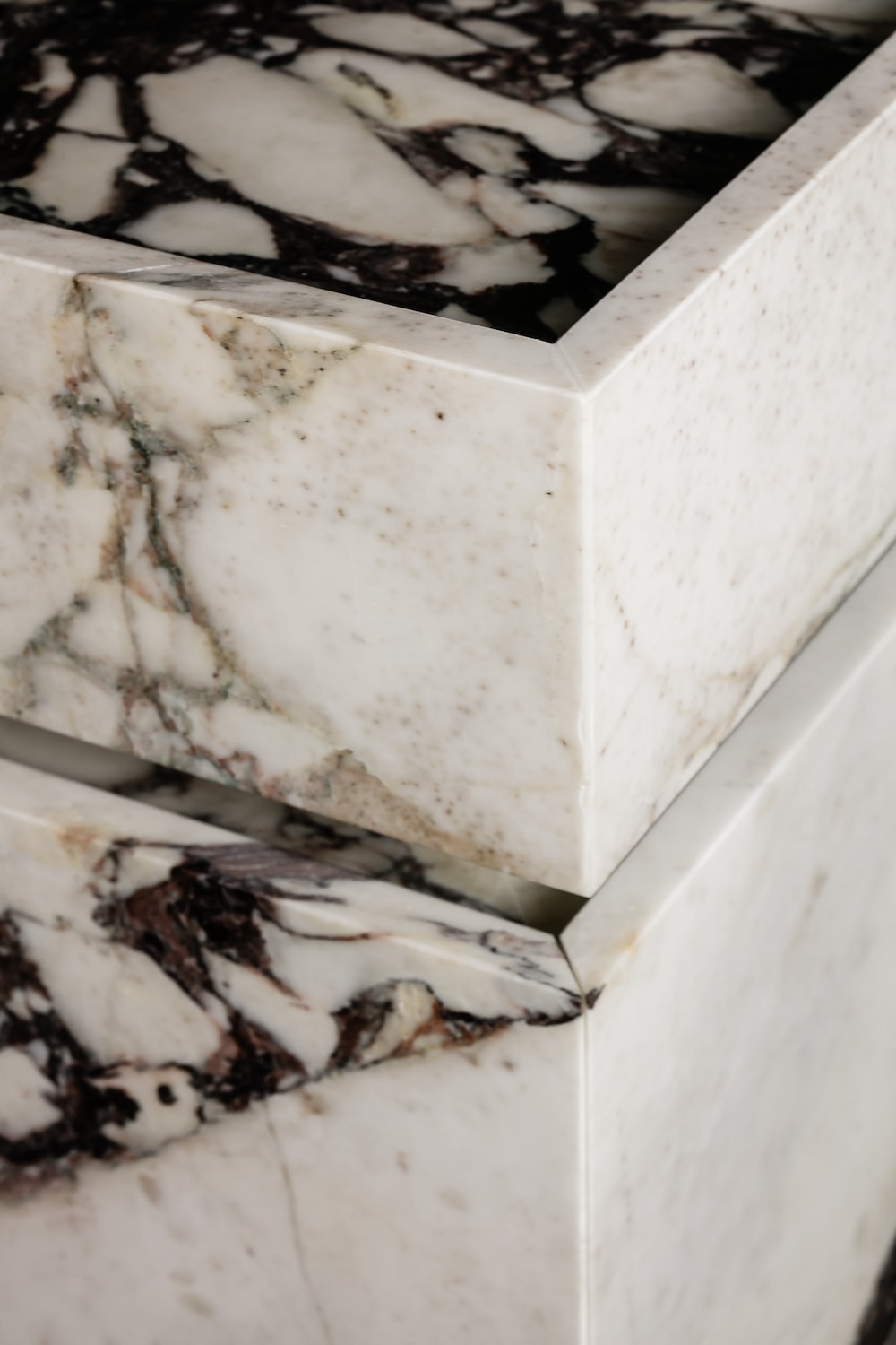 Close up of Venice marble vanity corner showing precision joinery and Calacatta Viola stone craftsmanship