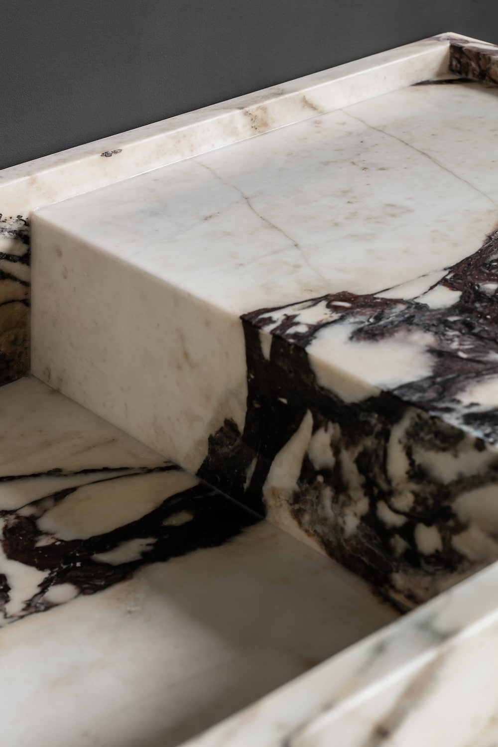 Close up of Venice marble vanity showing thick edge detail and Calacatta Viola vein matching craftsmanship