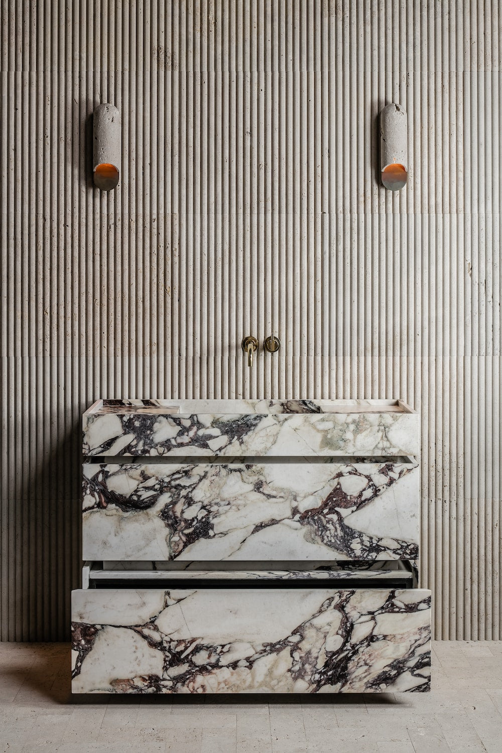 Venice marble vanity in Calacatta Viola natural stone with lower drawer open showing internal storage detail