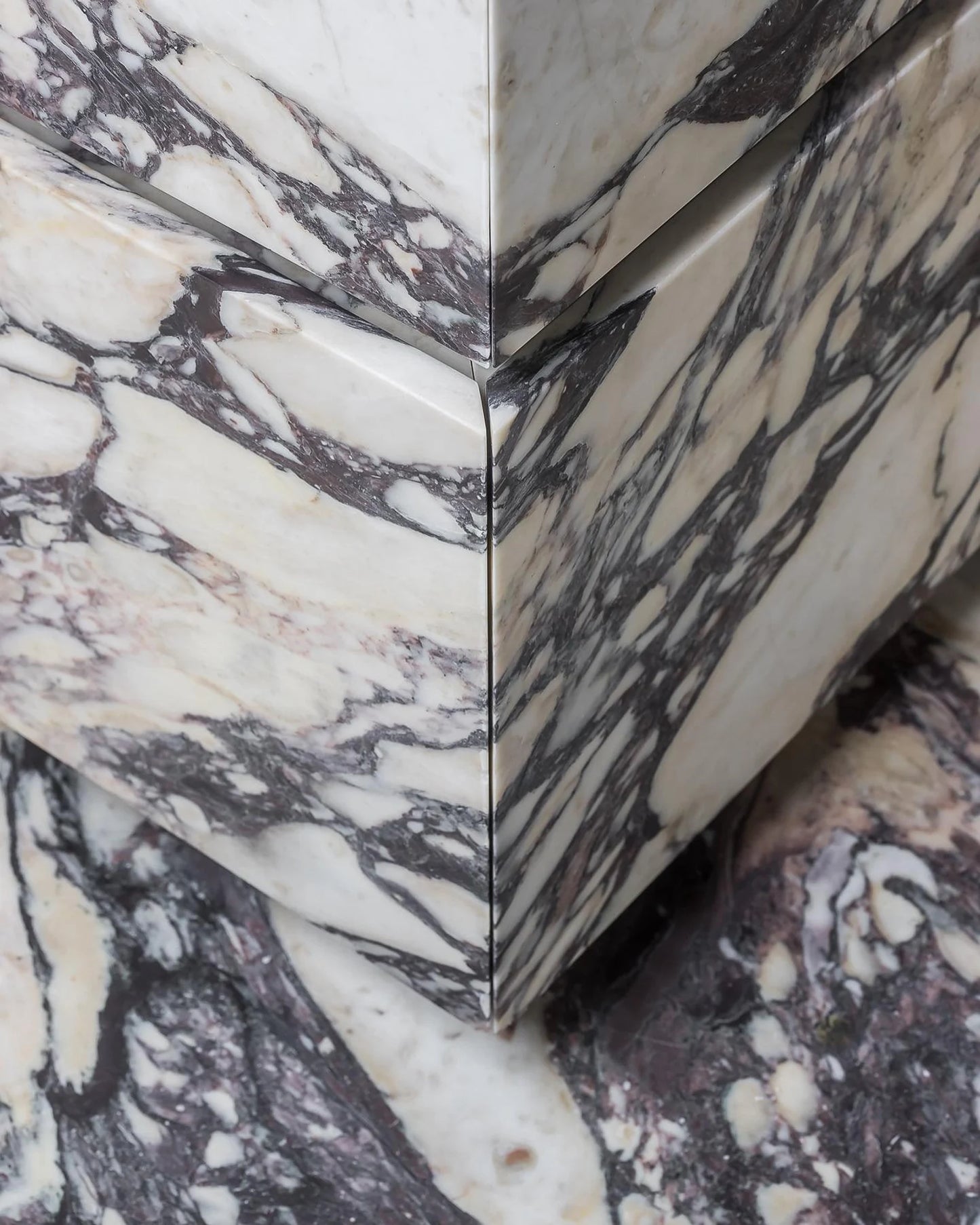 Close up of Venice marble vanity showing mitered corner and continuous Calacatta Viola veining