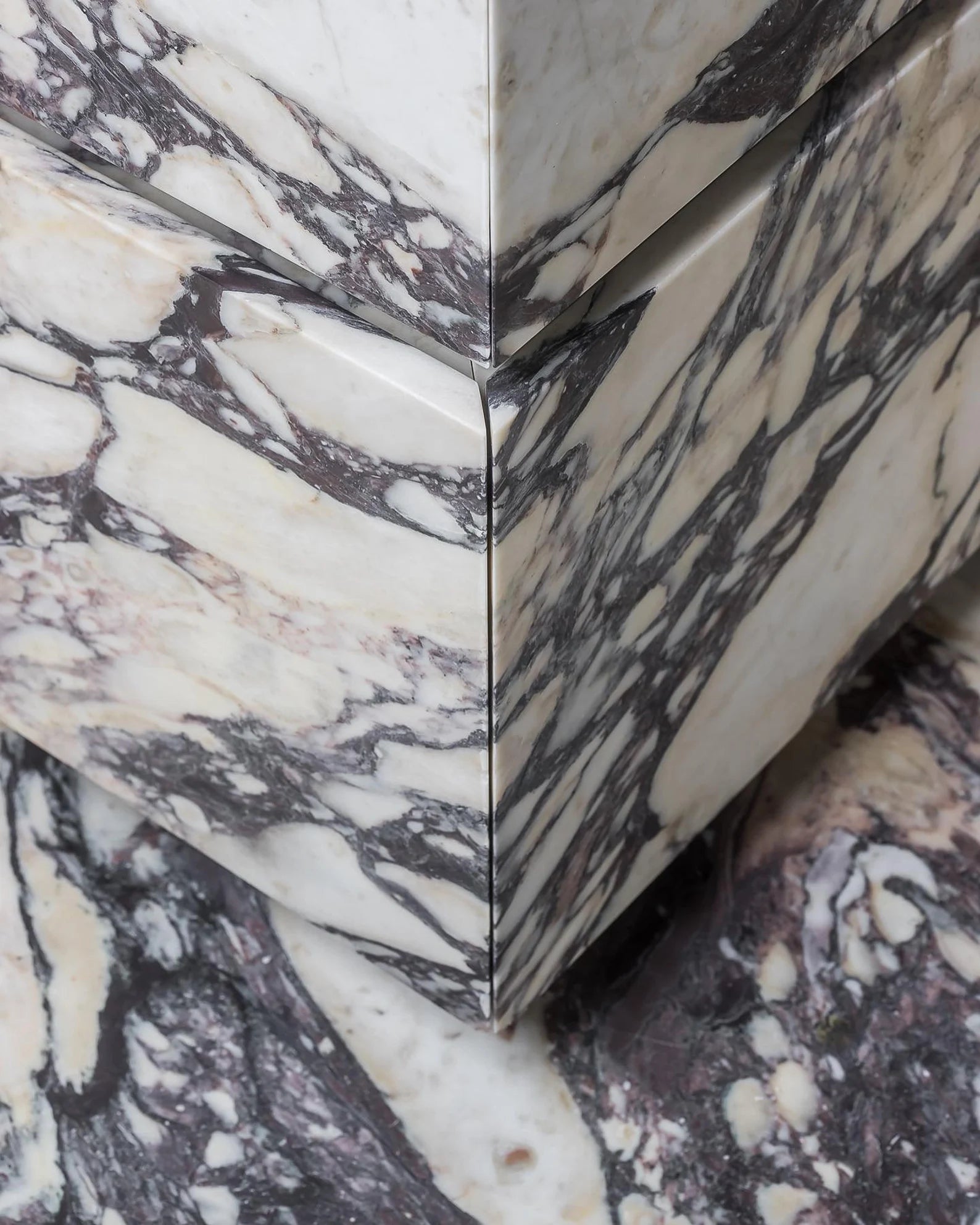 Close up of Venice marble vanity showing mitered corner and continuous Calacatta Viola veining