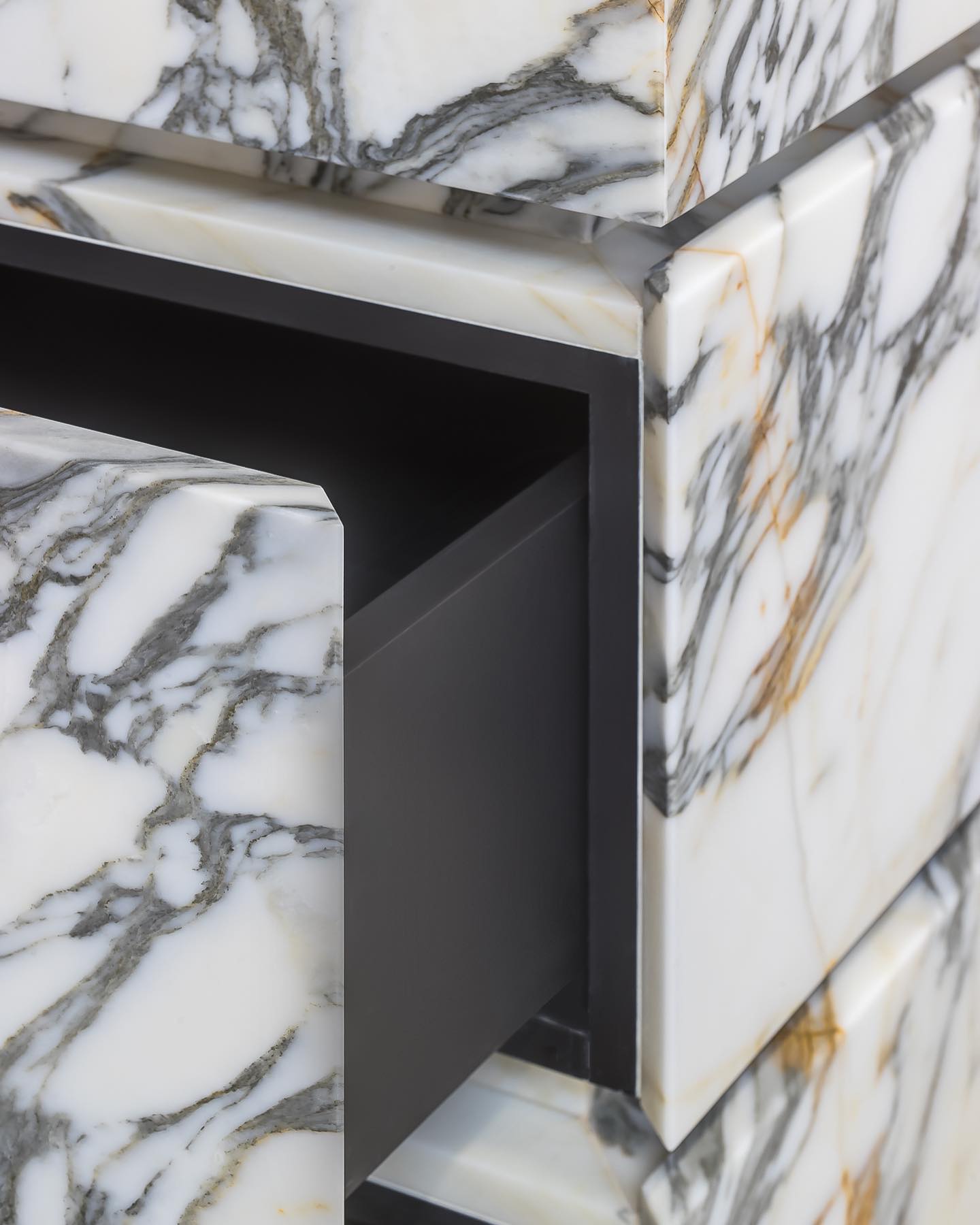Close up of Venice marble vanity showing hidden drawer system and internal structure with marble front panels