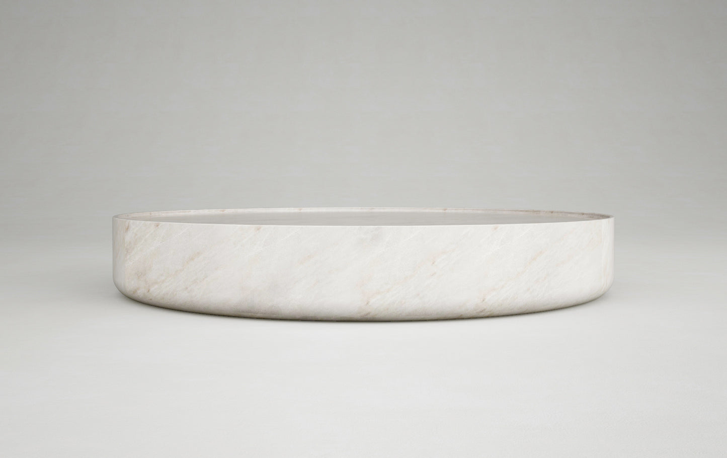 Vicenza round travertine coffee table side view minimalist stone furniture