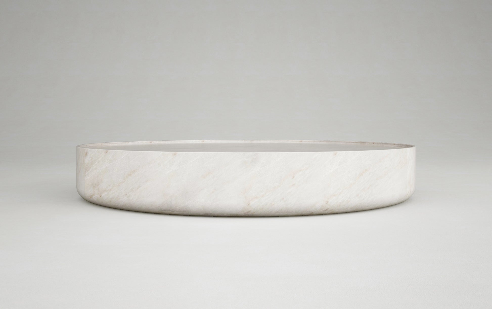 Vicenza round travertine coffee table side view minimalist stone furniture